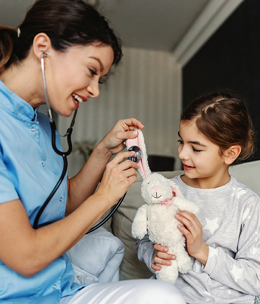 Nurse comforting child during exam at home